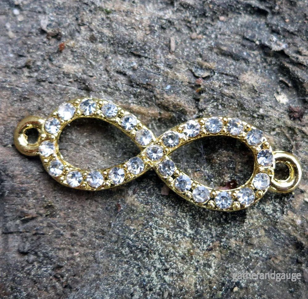 Connector Infinity – Evighetstecken med Strass Guldfärgad 33x10mm 1 styck Connector Infinity – Evighetstecken med Strass Guldfärgad 33x10mm 1 styck
