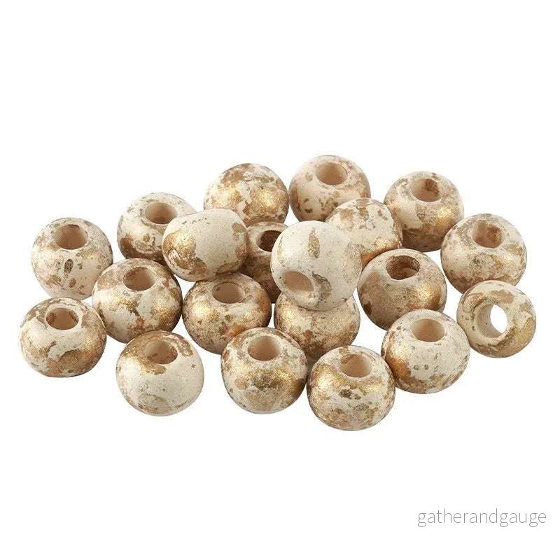 Porslinspärla – Rund vit med guldstänk, 8mm 1 styck Porslinspärla – Rund vit med guldstänk, 8mm 1 styck