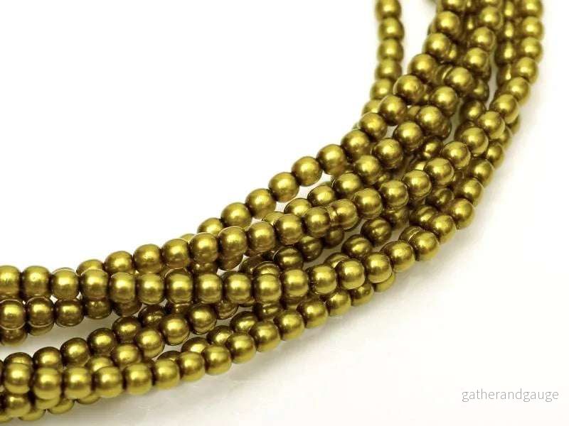 Tjeckiska vaxade glaspärlor - Shiny Olive 2mm, 1 sträng
