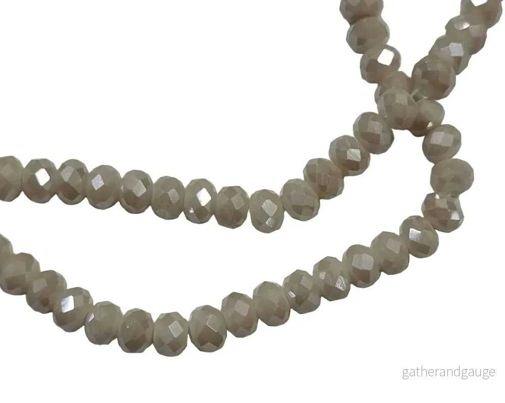 Facetterade glaspärlor - Opak beige AB, 6x4mm 1 sträng - Bild 2