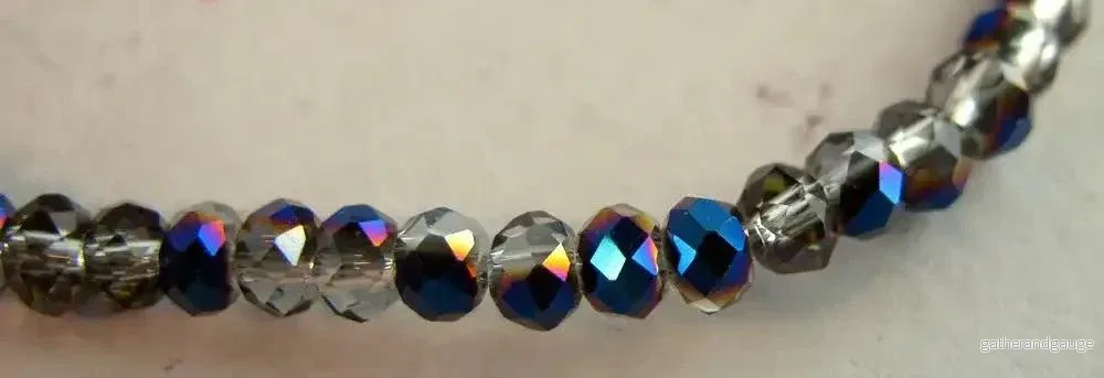 Facetterade glaspärlor – Klar/Olja, 3x2mm, 1 sträng Facetterade glaspärlor – Klar/Olja, 3x2mm, 1 sträng