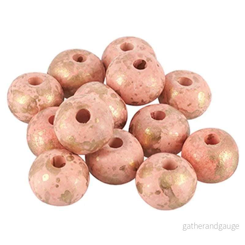 Porslinspärla – Rund rosa med guldstänk 12mm 1 styck Porslinspärla – Rund rosa med guldstänk 12mm 1 styck