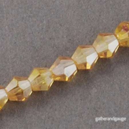 Glaspärlor Bicone – Goldenrod, 2x3mm, 1 sträng Glaspärlor Bicone – Goldenrod, 2x3mm, 1 sträng