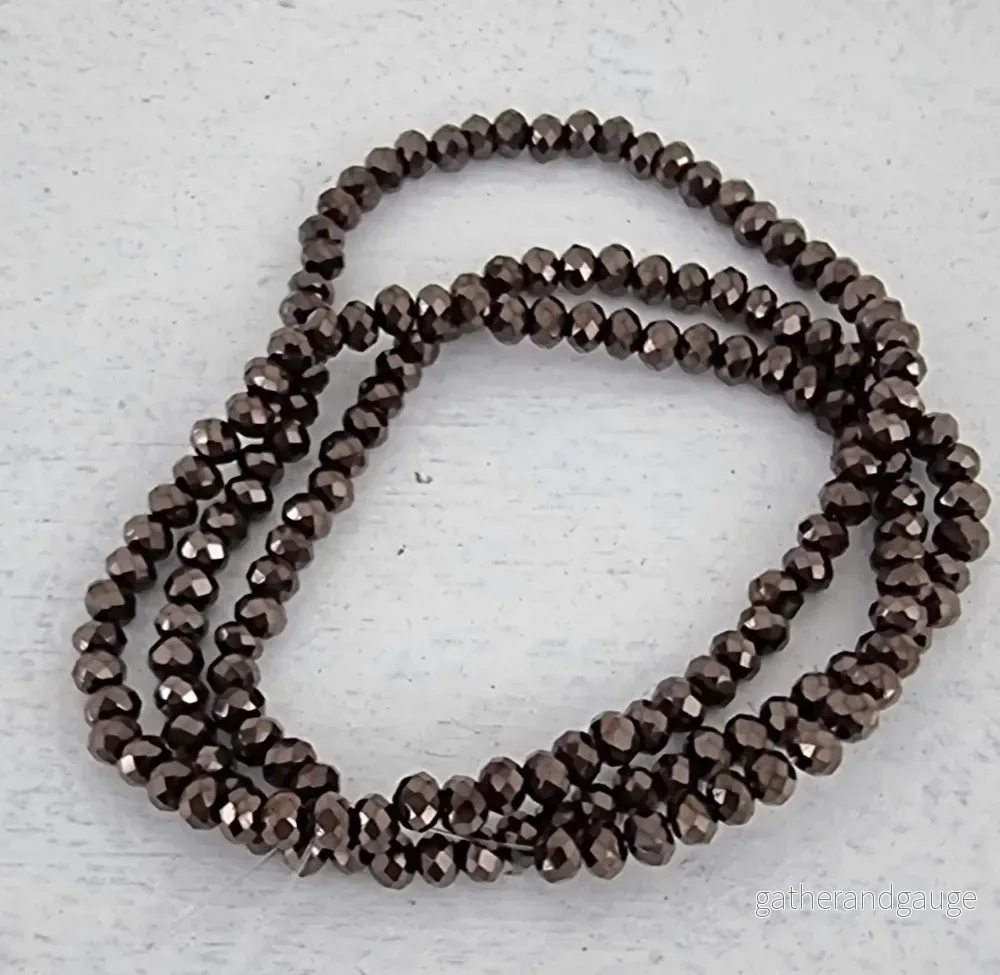 Facetterade glaspärlor – Gunmetalfärgade, 3×2.5mm 1 sträng