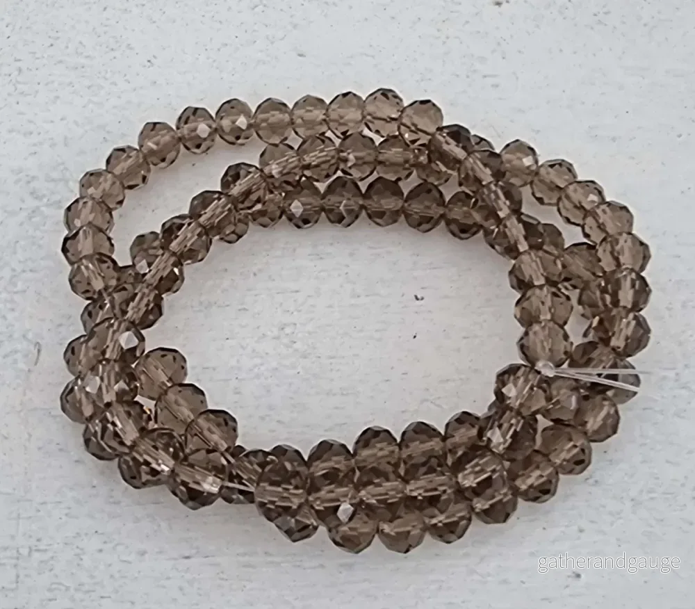 Facetterade glaspärlor - Rökgrå, 6x4mm 1 sträng