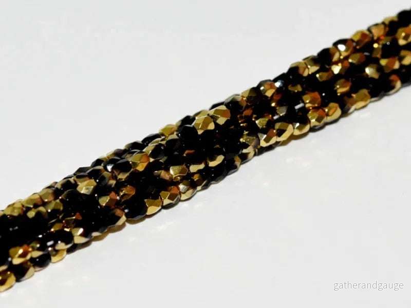 Tjeckiska Firepolish - Jet Amber 2mm, 1 sträng