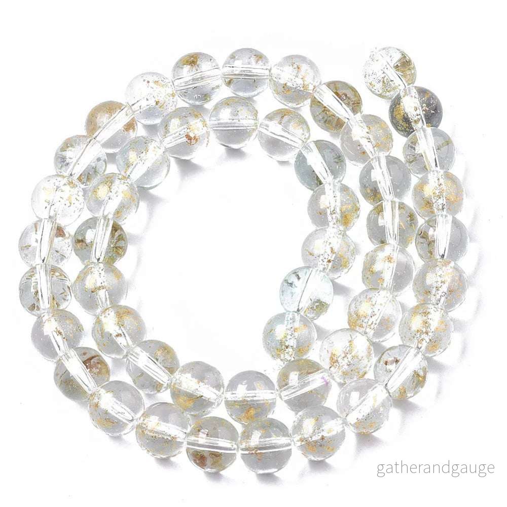 Glaspärlor Rund – Klar/Ljusblå Guldshimmer 8mm 1 sträng Glaspärlor Rund – Klar/Ljusblå Guldshimmer 8mm 1 sträng