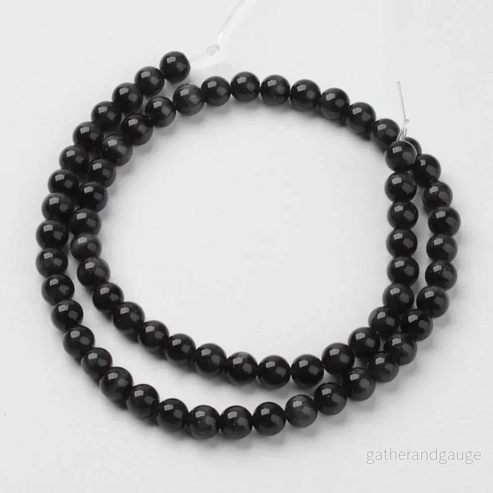 Cat´s eye pärlor – Rund Svart 8mm, 1 sträng